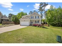 Charming two-story home with a well-manicured lawn and lovely landscaping at 503 Mugo Pine Ct, Wendell, NC 27591