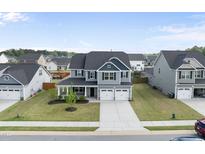 Beautiful two-story home with a two-car garage and well-maintained lawn at 509 National Dr, Clayton, NC 27520