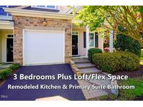 Charming townhome featuring a brick facade and a one-car garage at 5515 S Roxboro St # 23, Durham, NC 27713