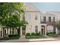Charming two-story townhome with a well-maintained lawn and inviting front entrance at 5710 Corbon Crest Ln, Raleigh, NC 27612