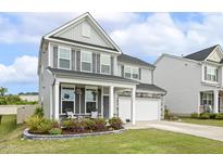 Charming two-story home with a well-manicured lawn and inviting front porch at 575 Dawley Dr, Fuquay Varina, NC 27526