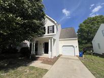 Charming two-story home with white siding, black shutters, and attached one car garage at 620 Hanska Way, Raleigh, NC 27610