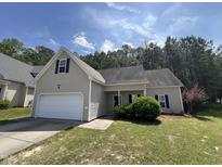 Charming home with a well-manicured lawn, attached garage, and traditional architectural details at 633 Prickly Pear Dr, Fuquay Varina, NC 27526