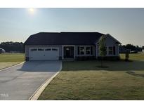 Charming single-story home with a well-manicured lawn and a two-car garage at 72 Ruskin Dr, Smithfield, NC 27577