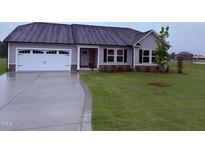 Charming single-story home with gray siding, a two-car garage, and well-manicured lawn at 72 Ruskin Dr, Smithfield, NC 27577