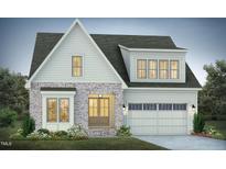 Charming two-story home with gray brick, white siding, an attached two-car garage, and manicured landscaping at 761 W Holly Springs Rd, Holly Springs, NC 27540