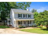 Charming two-story home with a welcoming front porch and beautifully landscaped front yard at 8009 Tobin Pl, Raleigh, NC 27612