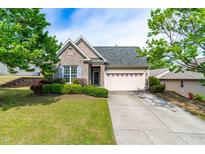 Charming home with well-manicured front yard, lush landscaping, and a convenient two-car garage at 8525 Holdenby Trl, Raleigh, NC 27616