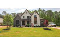 Beautiful two-story home boasts a manicured lawn and a blend of stone and siding accents for striking curb appeal at 1108 Delilia Ln, Wake Forest, NC 27587