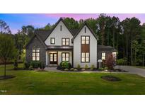 Stunning two-story home featuring stone accents, white siding, and a lush green lawn at 1108 Delilia Ln, Wake Forest, NC 27587