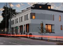 Contemporary two-story building showcasing modern design with unique brickwork and ample natural lighting at 1302 Chamblee Hill Ct, Raleigh, NC 27608