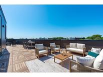 Inviting rooftop deck area perfect for relaxing with comfortable seating and city views at 1302 Chamblee Hill Ct, Raleigh, NC 27608