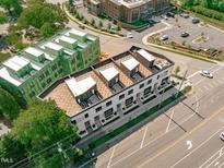Modern townhomes featuring rooftop terraces and contemporary design, with street and parking area views at 1308 Chamblee Hill Ct, Raleigh, NC 27608