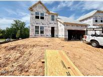 New two-story home featuring a garage, large windows, and situated on a lot during the construction phase at 17 Spring Crest Dr # 68, Angier, NC 27501