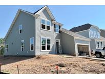 Charming two-story home featuring light blue siding and an attached two-car garage and unfinished yard at 17 Spring Crest Dr # 68, Angier, NC 27501