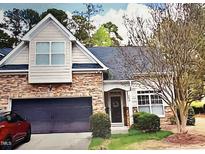 Charming home with stone accents, attached garage, and a well-maintained front lawn at 204 Plank Bridge Way, Morrisville, NC 27560