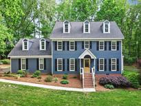 Charming two-story home with a landscaped yard and inviting entryway; perfect for Gathering living at 2169 Rawls Church Rd, Angier, NC 27501