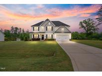 Beautiful two-story home featuring a manicured lawn and a two-car garage at 233 Berg St, Smithfield, NC 27577