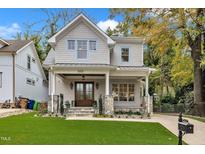 Charming two-story home featuring a welcoming front porch, manicured lawn, and beautiful stone accents at 2615 Bedford Ave, Raleigh, NC 27607