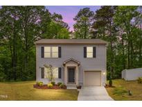 Charming two-story home with a well-manicured front yard and a one-car garage at 2800 Elsa Dr, Raleigh, NC 27610