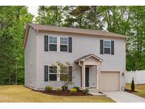 Charming two-story home with gray siding, black shutters, and a well-manicured lawn at 2800 Elsa Dr, Raleigh, NC 27610
