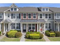 Charming townhome with inviting front porch and manicured landscaping showcasing a cozy curb appeal at 2821 Wilshire Hill Dr # 111, Raleigh, NC 27604