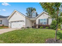 Charming single-Gathering home featuring a two-car garage, manicured lawn, and welcoming curb appeal at 3248 Castlerock Dr, Burlington, NC 27215