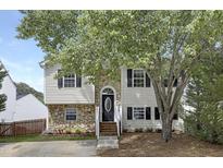 Charming two-story home featuring stone accents, black shutters, and a well-maintained front yard at 3613 Ranbir Dr, Durham, NC 27713