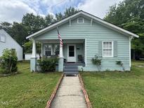 Charming home featuring a quaint front porch, well-maintained lawn, and classic American-style architecture at 514 E Lee St, Smithfield, NC 27577