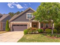 Charming home exterior with stone and siding, featuring a well-maintained lawn and mature landscaping at 5144 Niagra Dr, Chapel Hill, NC 27517