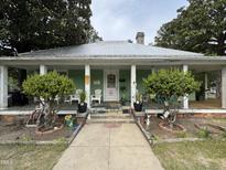 Charming single story home featuring a porch with columns and a metal roof at 515 E Woodall St, Smithfield, NC 27577