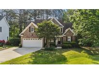 Beautiful two story brick home with mature landscaping, two car garage, and covered entry at 5705 Tannibark Ln, Fuquay Varina, NC 27526