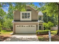 Charming two-story home with a two-car garage and neatly landscaped front yard at 8200 Shadow Stone Ct, Raleigh, NC 27613