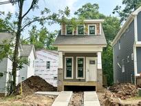 New construction home featuring craftsman style architecture with gray siding and a covered front porch at 901 Linwood Ave, Durham, NC 27701
