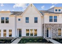 Charming new construction townhome with white siding and manicured landscaping at Lot 6 Cooper St, Sanford, NC 27330