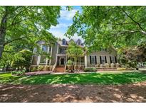 Charming two-story home with a landscaped front yard, brick steps and covered front porch at 101 Abbotsford Ct, Durham, NC 27712