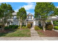 Charming townhouse with a manicured lawn and mature trees, offering curb appeal at 1204 Maroon Dr, Durham, NC 27713