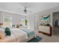 Bright bedroom with neutral walls, ceiling fan, and decorative rug and pillows at 124 Myatt Fern Dr, Garner, NC 27529