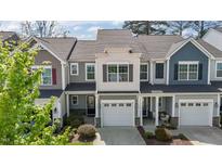 Charming townhome featuring an attached garage, beautiful stonework, and a well-maintained front yard at 124 Myatt Fern Dr, Garner, NC 27529