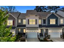Charming townhome with a well-manicured lawn, attached garages, and inviting curb appeal at 124 Myatt Fern Dr, Garner, NC 27529