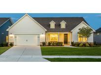 Charming one-story home boasting a pristine lawn, covered porch and attached two-car garage at 1605 Garden Park Cir, Fuquay Varina, NC 27526