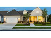 Charming single-Gathering home with a well-manicured lawn and attached garage at 1609 Garden Park Cir, Fuquay Varina, NC 27526