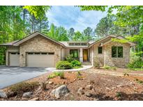 Beautiful stone and siding home with a well-manicured front yard and a two-car garage at 201 Summergate Cir, Chapel Hill, NC 27516