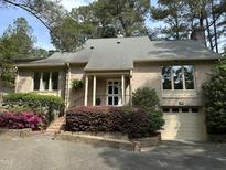 Charming brick home with landscaped front yard, mature trees, and inviting entryway at 202 Selkirk Pl, Durham, NC 27707
