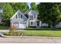Charming two-story home with well-manicured lawn and mature trees at 216 Billingrath Turn Ln, Cary, NC 27519