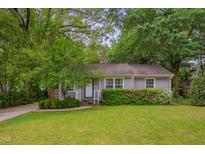 Charming single-story home featuring a well-manicured lawn and beautiful flower bushes at 2442 Stevens Rd, Raleigh, NC 27610