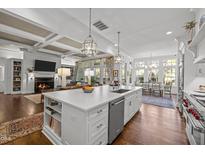 Bright open-concept kitchen featuring a large island, stainless steel appliances, and seamless flow into the living area at 2908 Stubble Field Dr, Raleigh, NC 27613