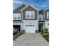 Charming two-story townhome with attached garage and neutral siding at 313 Kineton Woods Way Way, Garner, NC 27529