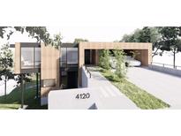 Stunning modern home featuring wood siding, large windows, and covered parking at 4120 Picardy Dr, Raleigh, NC 27612