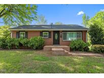 Charming brick home with a manicured lawn and inviting front entrance at 623 Oakgrove Dr, Graham, NC 27253
